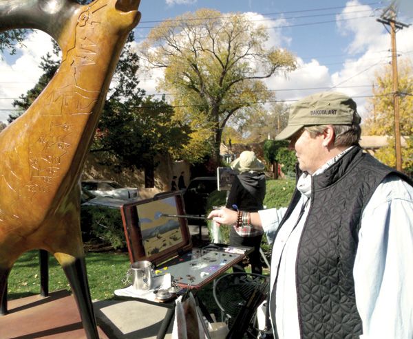 An artist works along Canyon Road at last year’s Spring Art Festival.