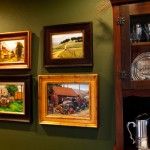 Four works depicting old trucks by Teresa Vito, Carol Jenkins, Tom Lockhart, and Douglas Morgan in Bullard’s mountain home.