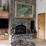 A large painting by Ed Kucera hangs above the living room fireplace.