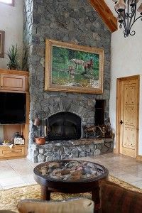 A large painting by Ed Kucera hangs above the living room fireplace.